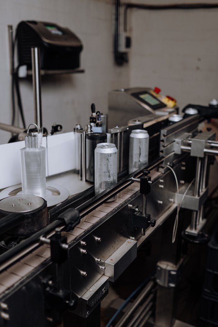 Close-up view of an automated canning line in a brewery, showcasing modern manufacturing technology.